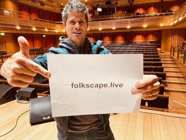 An artist welcoming audiences to folkscape.live from the stage